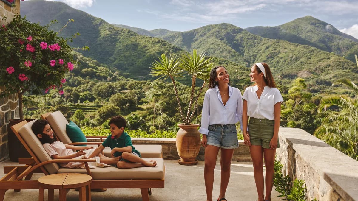 Family with young children smiling and enjoying the pool and terrace of a luxury country estate in Antioquia