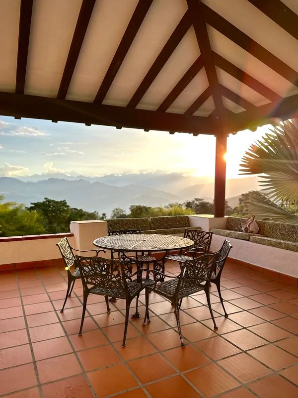 Terraza mirador de La Juana con comedor de hierro forjado y vista al atardecer