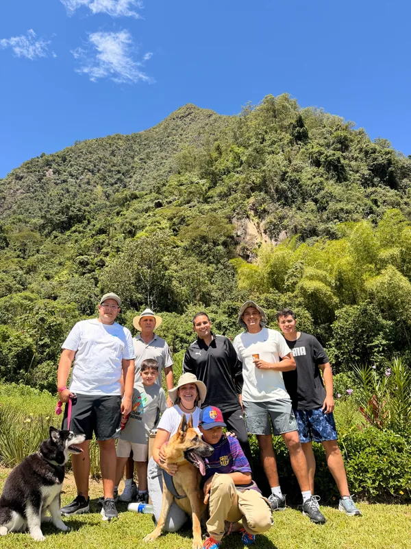 Family and visitors with their dogs enjoying a sunny day at the foot of Cerro Tusa
